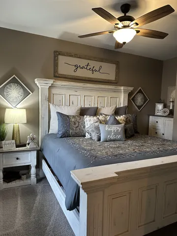 a bedroom with a bed and ceiling fan