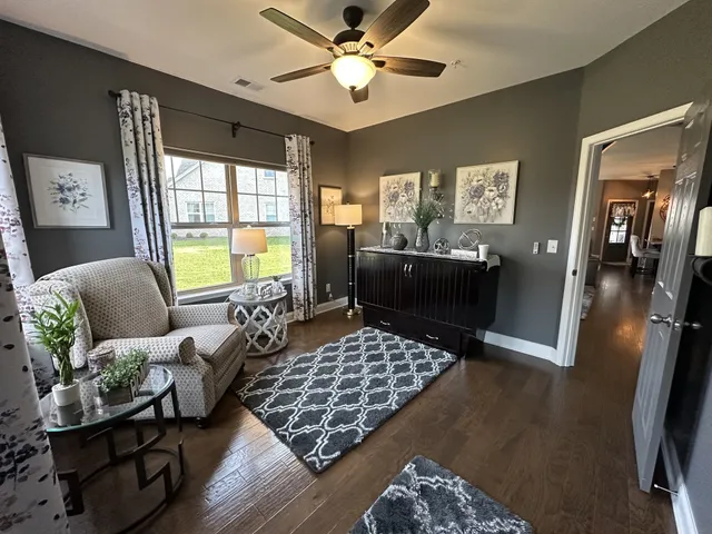 a living room with furniture rug and window