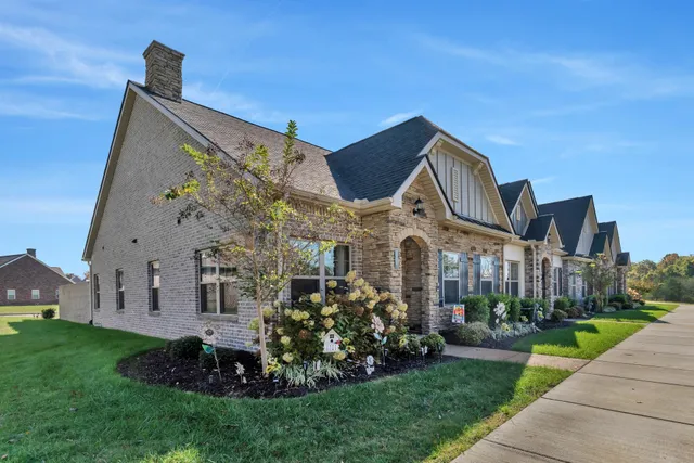 a front view of a house with a garden