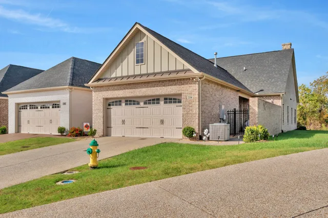 a front view of a building with a garden