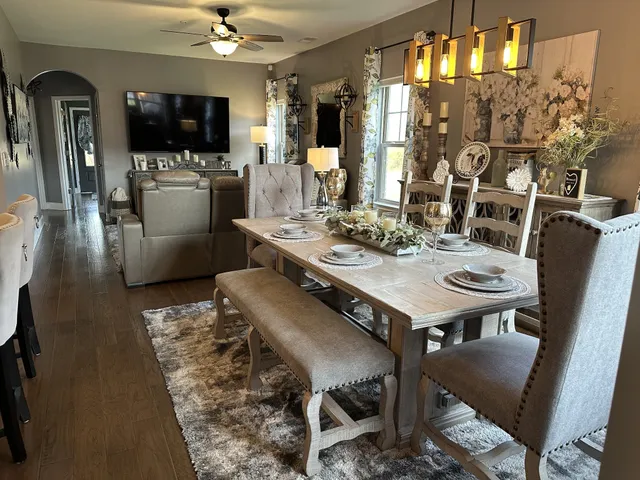a view of a dining room with furniture and a flat screen tv