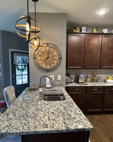 a kitchen with sink a window and dining table