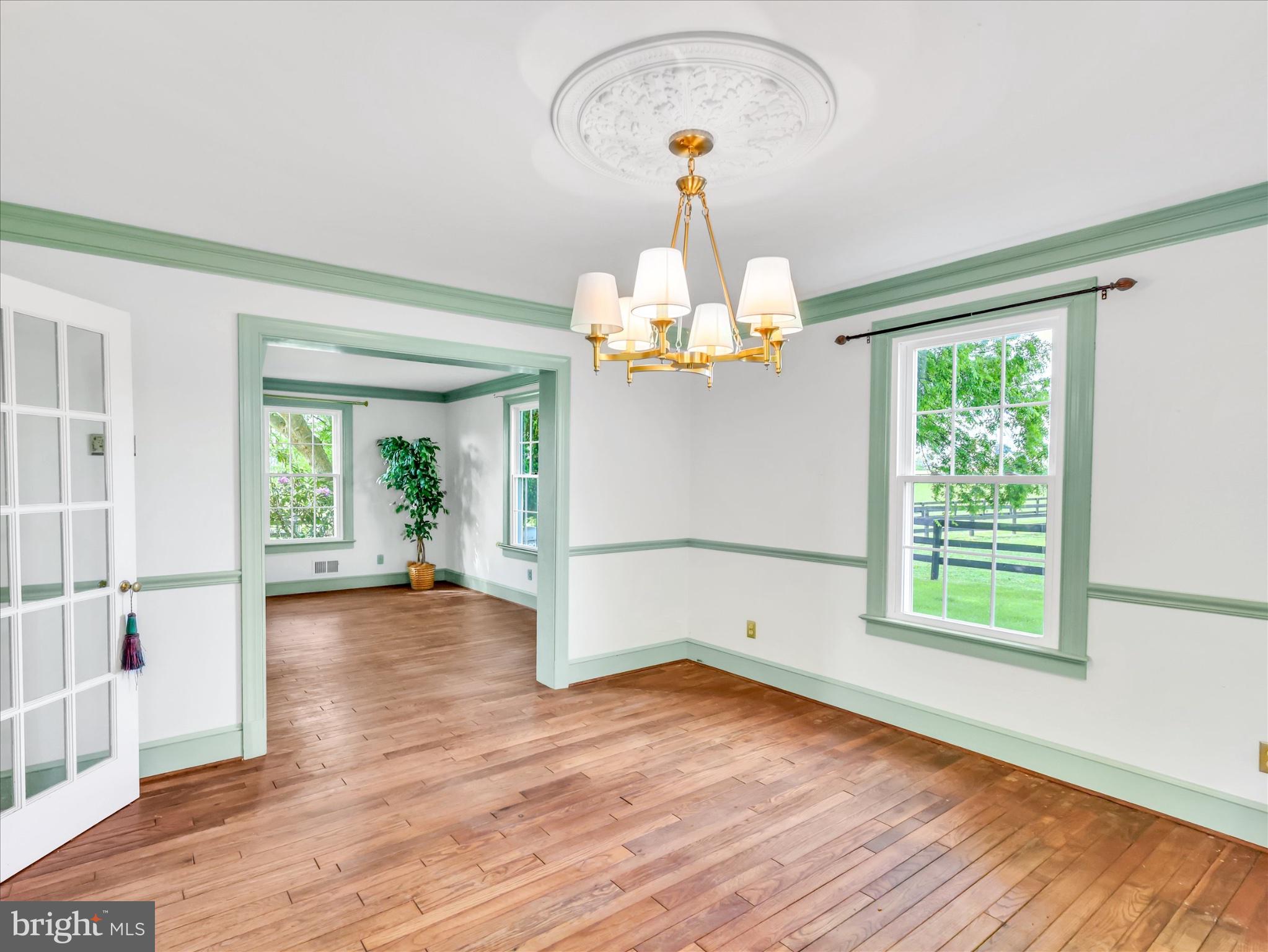 19255 Telegraph Springs Road Purcellville, VA 20132 - Photo 30 of 107 a view of a room with wooden floor gym equipment and windows