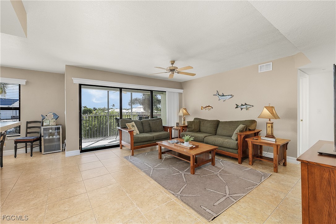 16641 Stringfellow Road, Unit 502 Bokeelia, FL 33922 - Photo 12 of 43 a living room with furniture and a gate