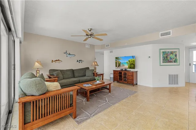 a bedroom with a large bed and a flat tv screen on dresser