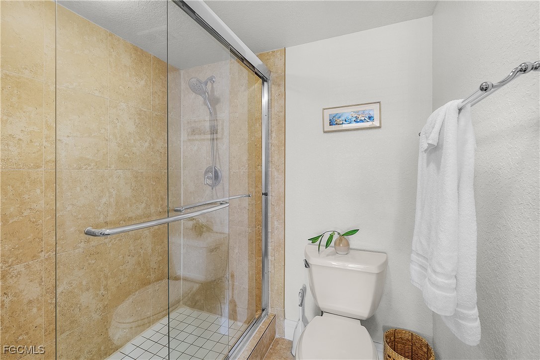 16641 Stringfellow Road, Unit 502 Bokeelia, FL 33922 - Photo 22 of 43 a bathroom with a shower and toilet