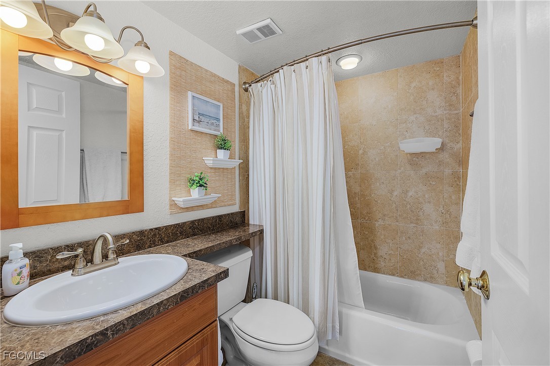 16641 Stringfellow Road, Unit 502 Bokeelia, FL 33922 - Photo 26 of 43 a bathroom with a sink a toilet and shower