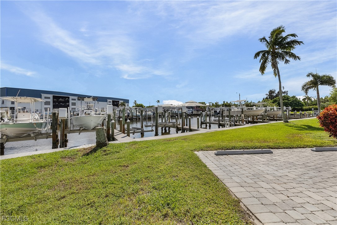 16641 Stringfellow Road, Unit 502 Bokeelia, FL 33922 - Photo 40 of 43 a swimming pool with outdoor seating and garden