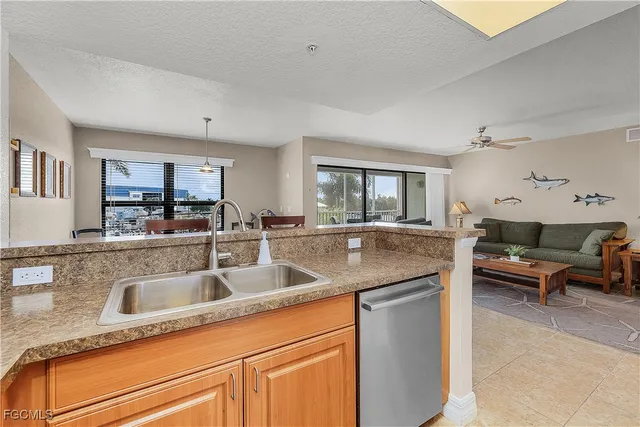 a kitchen with metallic refrigerator freezer and a dishwasher