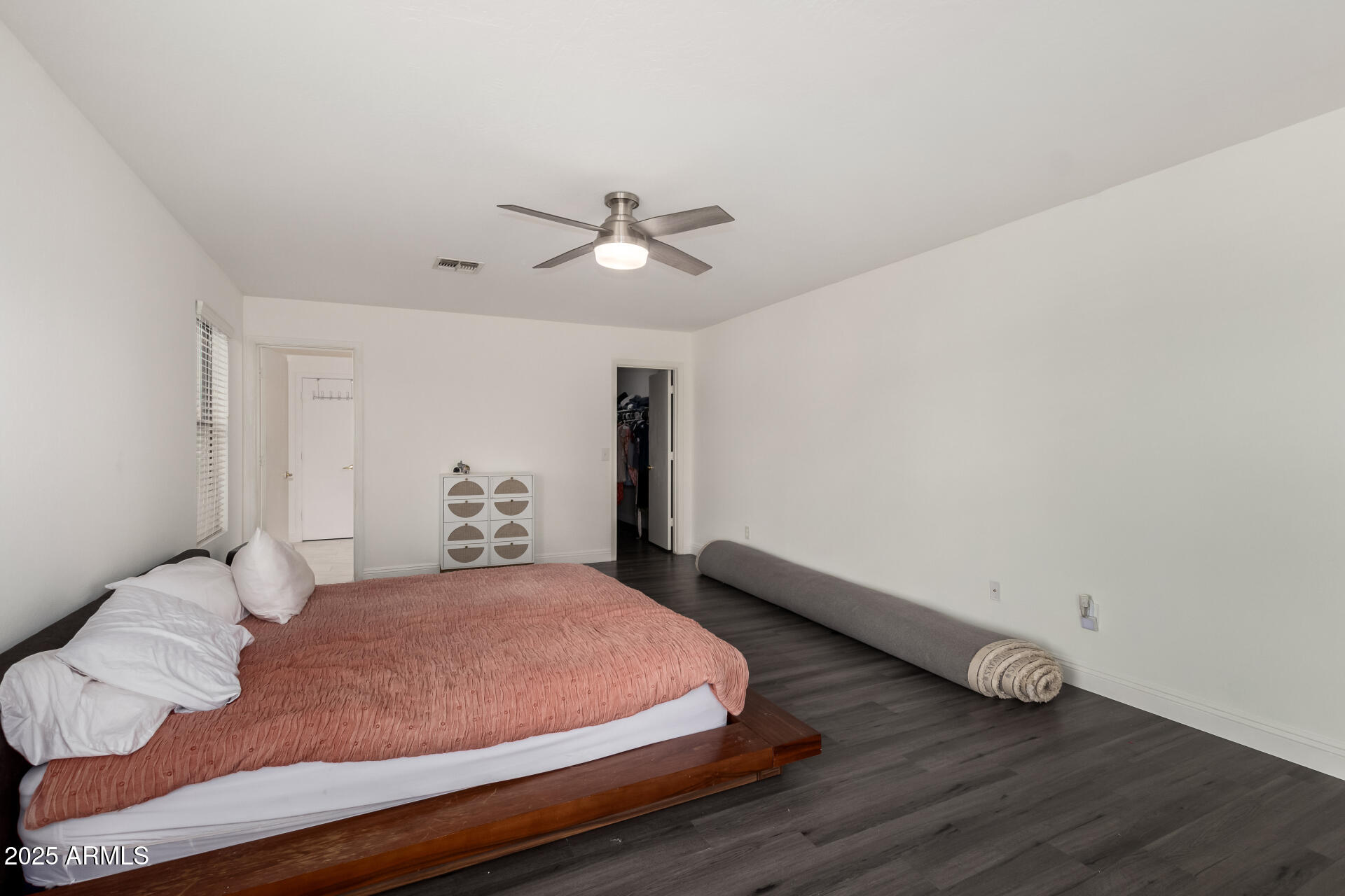 9415 West Eaton Road Phoenix, AZ 85037 - Photo 21 of 36 a bedroom with a bed and a ceiling fan