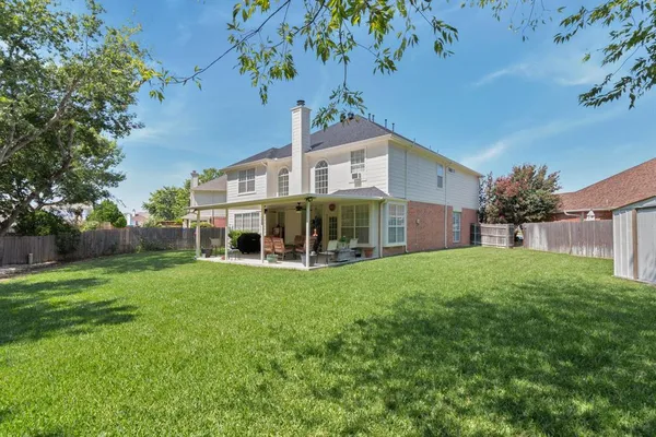 a view of a house with backyard sitting area and garden