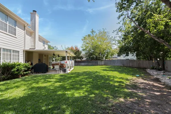 a view of a house with a yard and sitting area