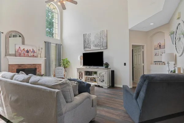 a living room with furniture a flat screen tv and a fireplace