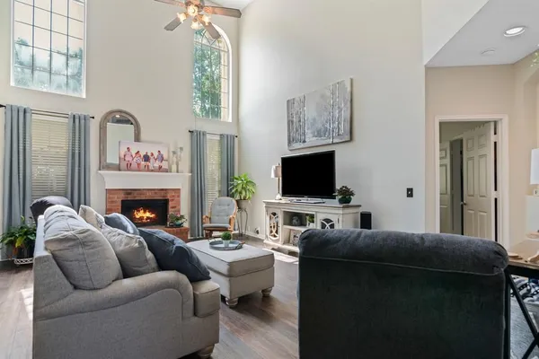 a living room with furniture a flat screen tv and a fireplace