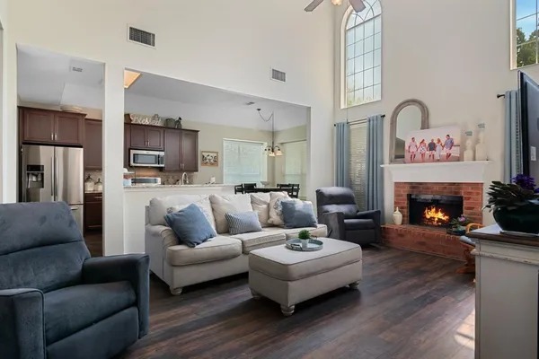 a living room with furniture fireplace and flat screen tv
