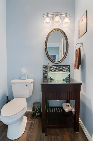 a bathroom with a toilet a sink and a mirror