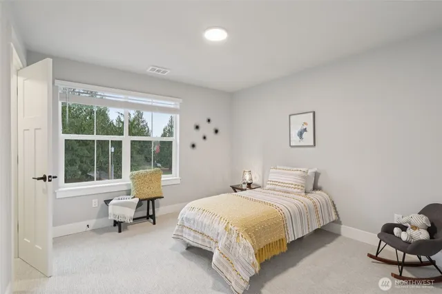 a spacious bedroom with a bed and a window