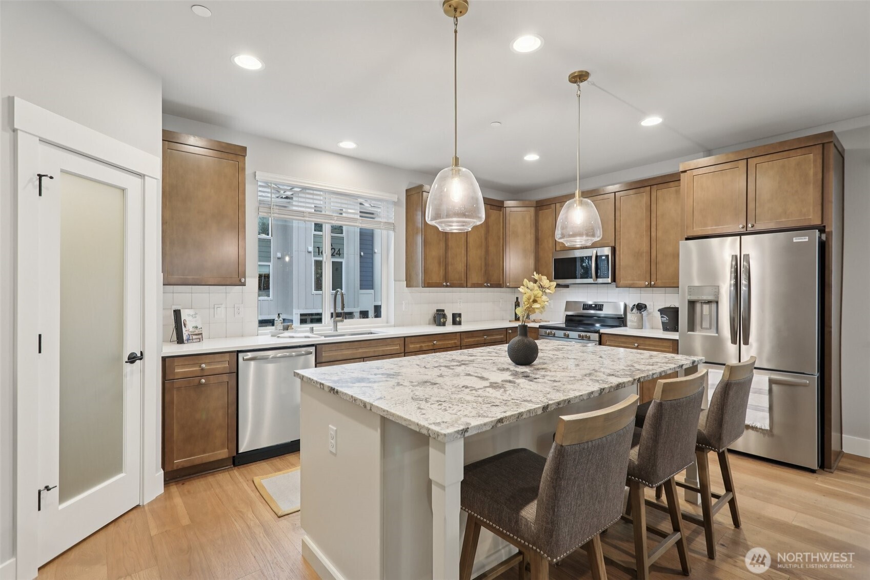 18 160th Place Southeast Bothell, WA 98012 - Photo 5 of 32 a kitchen with granite countertop a sink a center island stainless steel appliances and cabinets