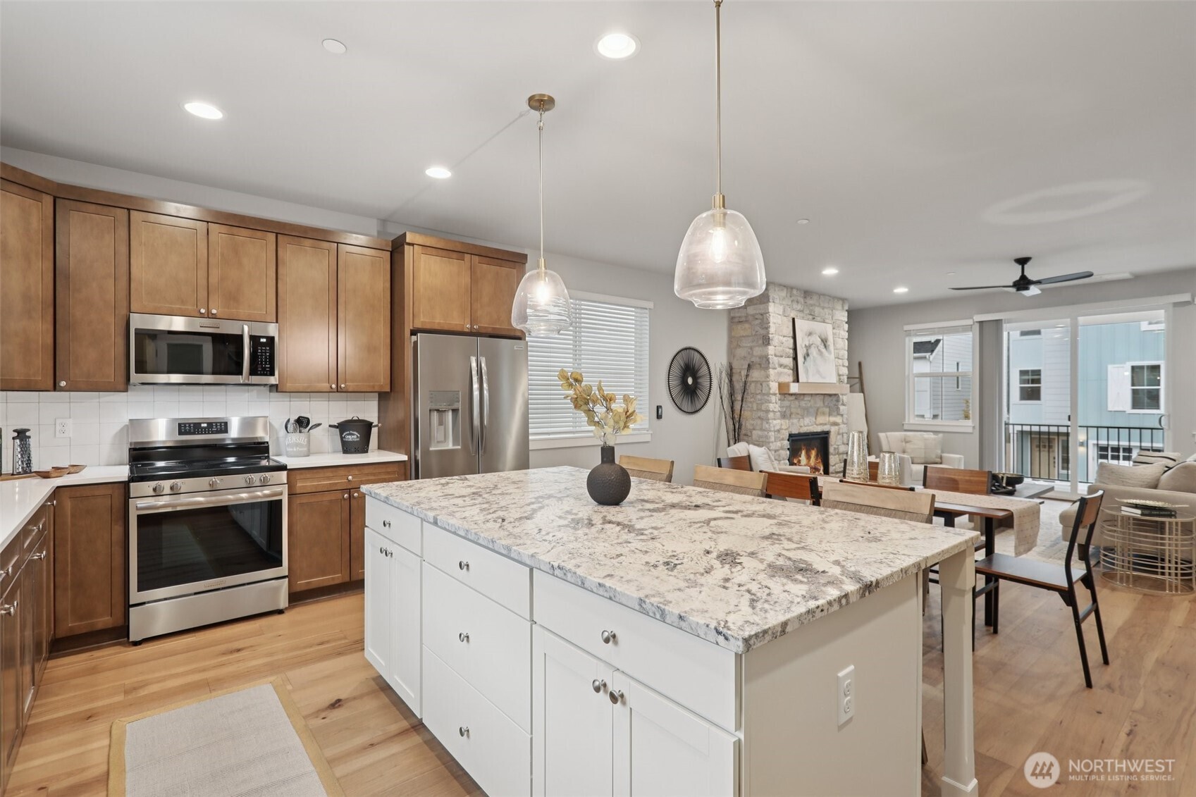 18 160th Place Southeast Bothell, WA 98012 - Photo 9 of 32 a kitchen with stainless steel appliances kitchen island granite countertop a sink and cabinets