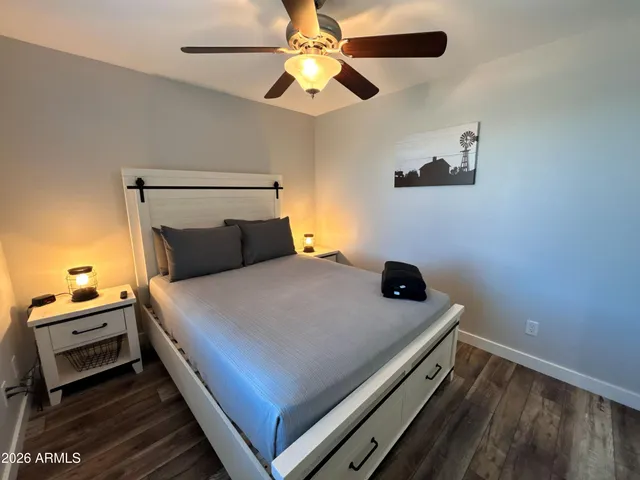 a bedroom with a bed and a ceiling fan