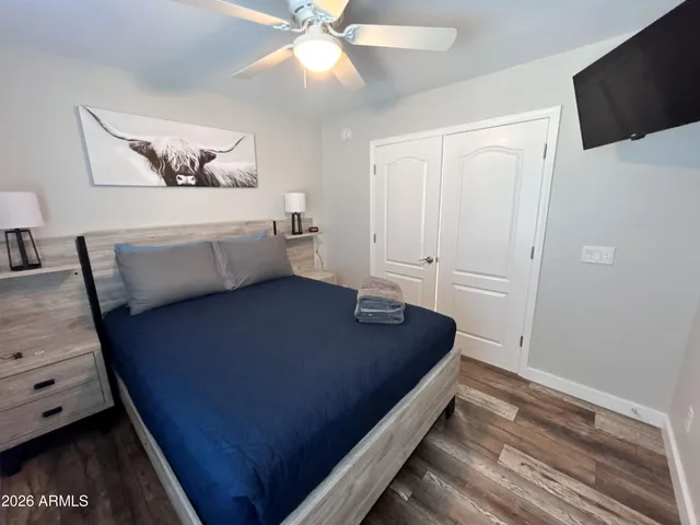 a room with a bed and a ceiling fan