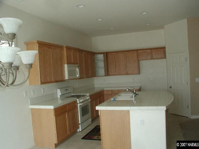 10431 Blockade Drive Reno, NV 89521 - Photo 3 of 7 a utility room with sink dryer and washer