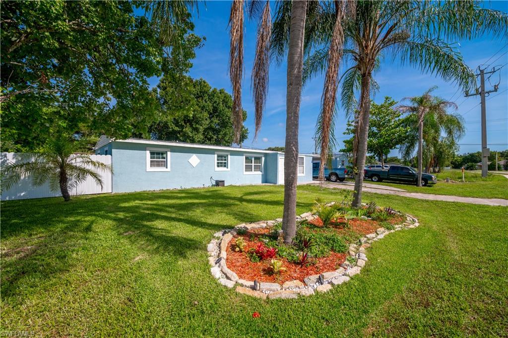 11 Alabama Road South Lehigh Acres, FL 33936 - Photo 1 of 30 a front view of house with yard and tree