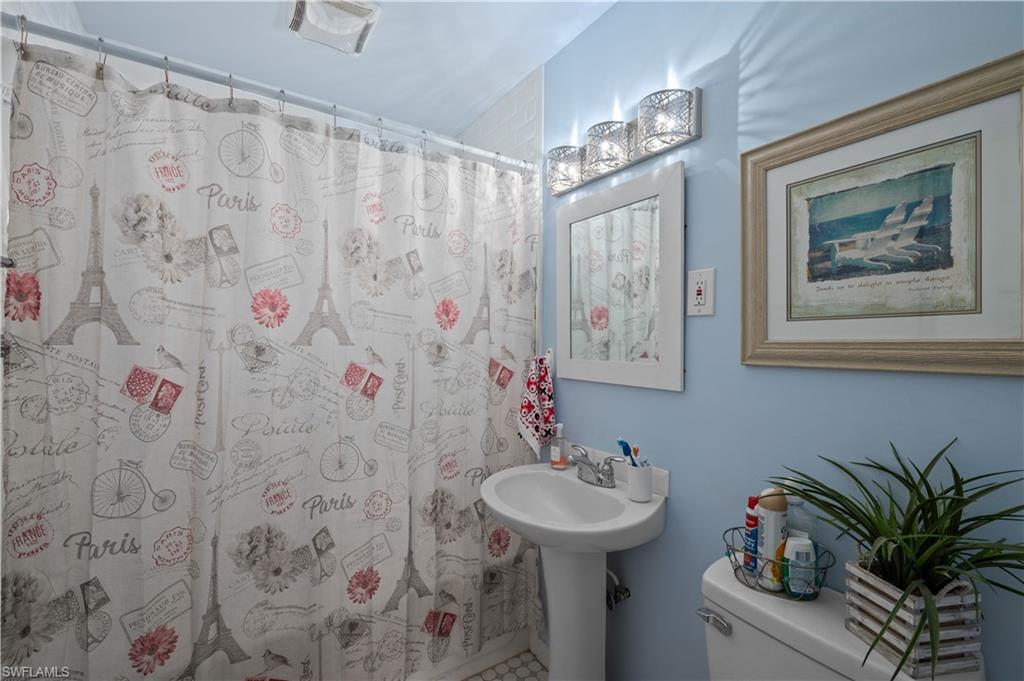 11 Alabama Road South Lehigh Acres, FL 33936 - Photo 12 of 30 a bathroom with a sink and a mirror
