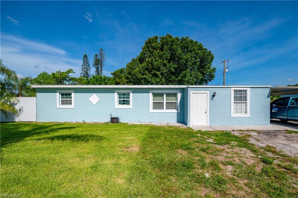 11 Alabama Road South Lehigh Acres, FL 33936 - Photo 2 of 30 a view of a house with a yard
