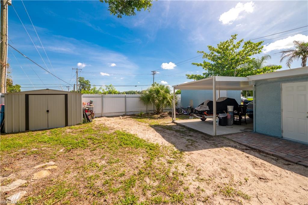 11 Alabama Road South Lehigh Acres, FL 33936 - Photo 24 of 30 a front view of a house with a yard and garage