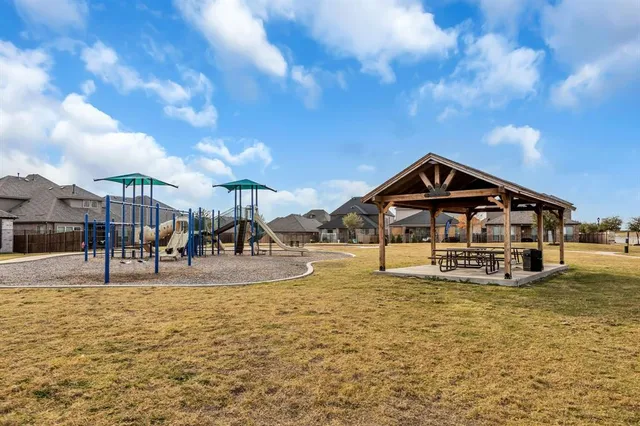 a swimming pool with outdoor seating and yard