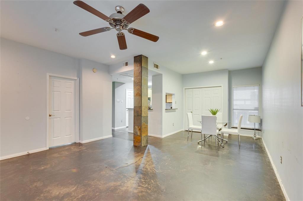 4104 North Hall Street, Unit 102 Dallas, TX 75219 - Photo 8 of 18 Spacious open-concept room featuring concrete flooring, a ceiling fan with wood-finish blades, and recessed lighting
