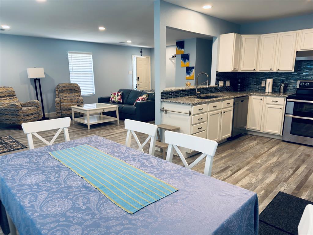 619 Rs County Road 3350 Emory, TX 75440 - Photo 11 of 40 a living room with furniture a wooden floor and kitchen view