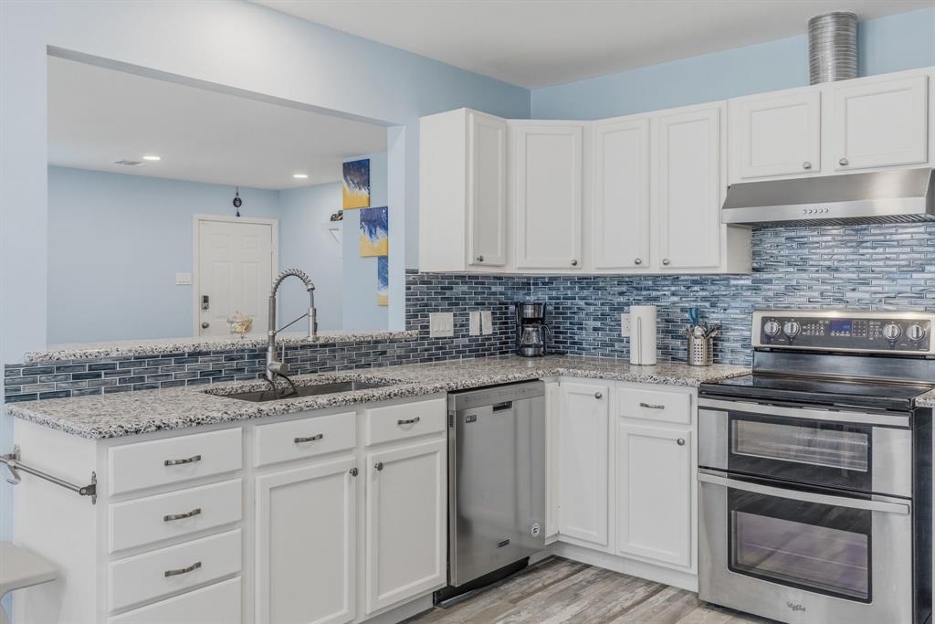 619 Rs County Road 3350 Emory, TX 75440 - Photo 12 of 40 a kitchen with granite countertop a sink stainless steel appliances and cabinets