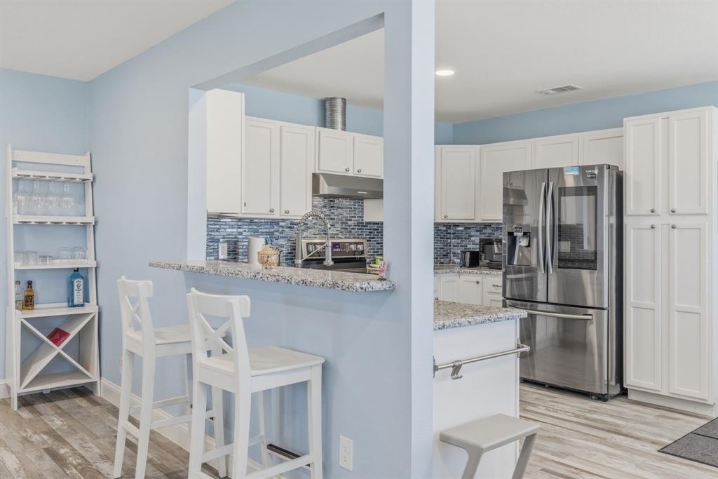 619 Rs County Road 3350 Emory, TX 75440 - Photo 14 of 40 a kitchen with stainless steel appliances granite countertop a refrigerator and white cabinets