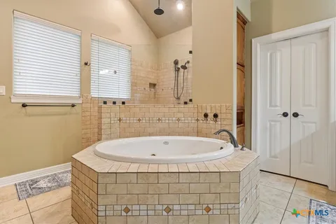 a bathroom with a bathtub and shower