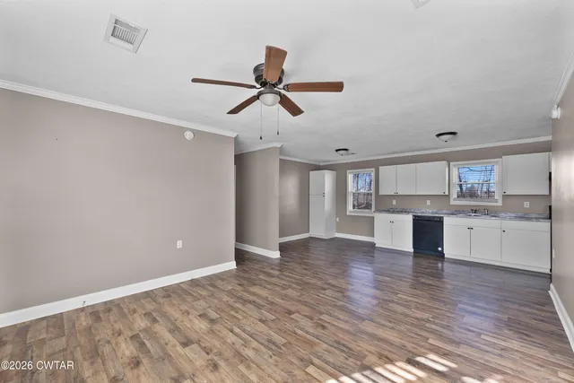 a kitchen with a sink cabinets and window