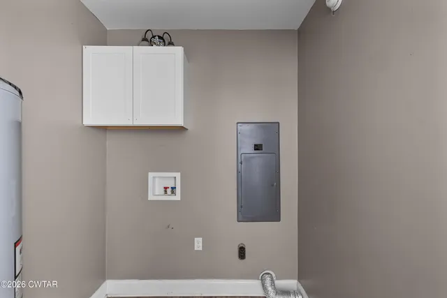 a view of a big room with wooden floor and windows