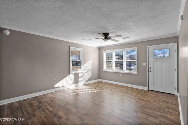 a view of a kitchen with wooden floor and a sink