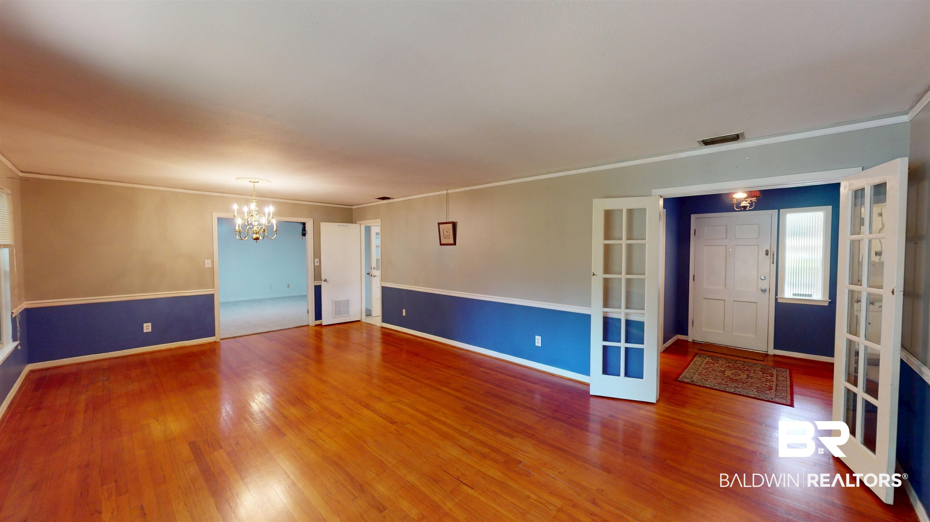 1075 Zurich Street Mobile, AL 36608 - Photo 13 of 35 Entrance foyer with crown molding, a chandelier, french doors, and hardwood / wood-style floors