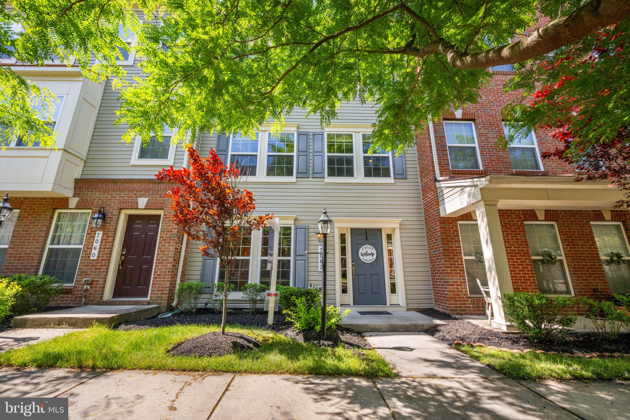7062 Foxton Way Hanover, MD 21076 - Photo 2 of 41 a front view of a house with a yard