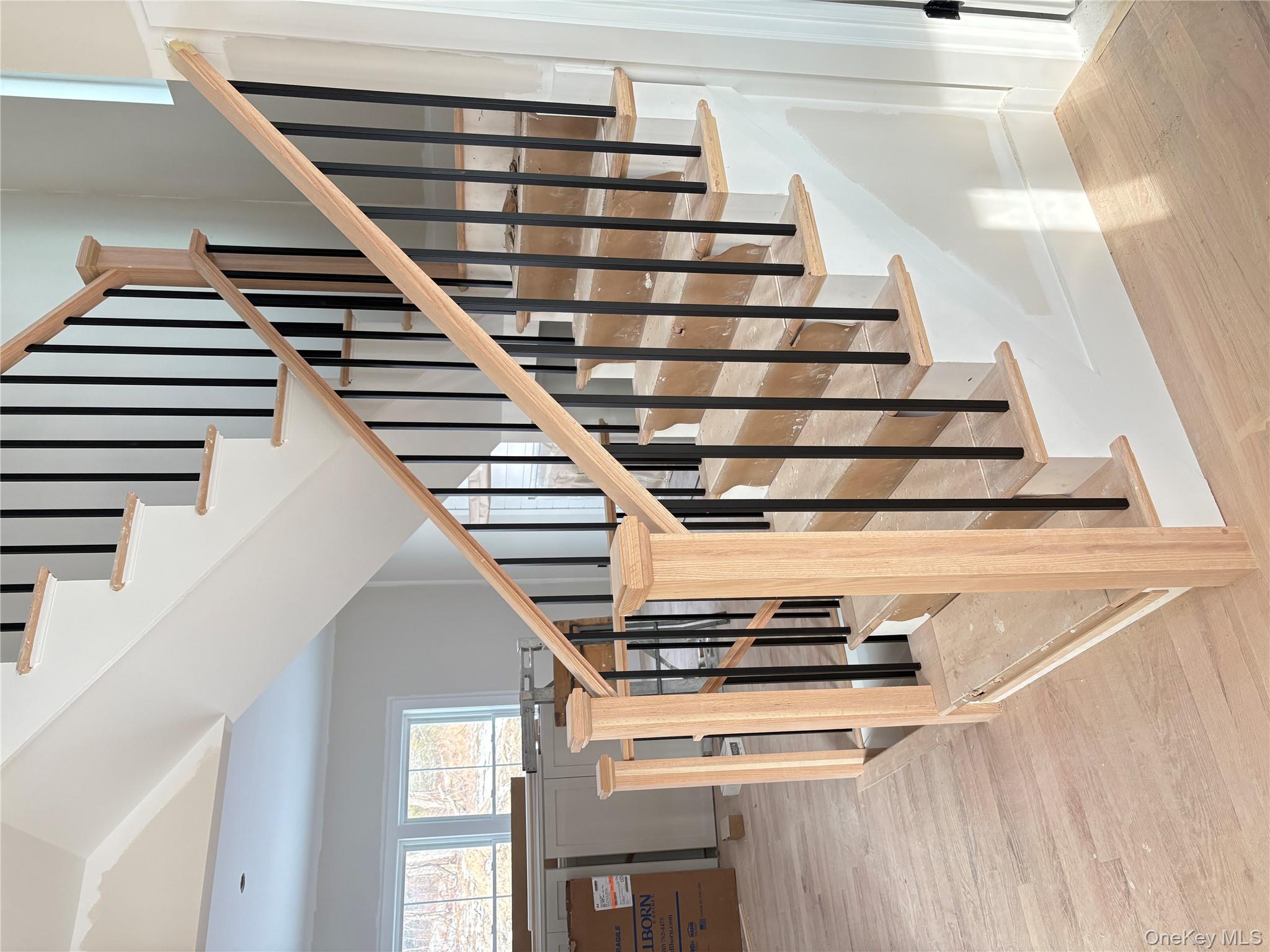 466 Wheeler Road Florida, NY 10921 - Photo 4 of 21 a view of staircase with lots of frames on wall and wooden floor