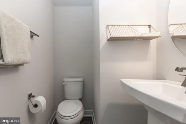 a bathroom with a sink a toilet and a window