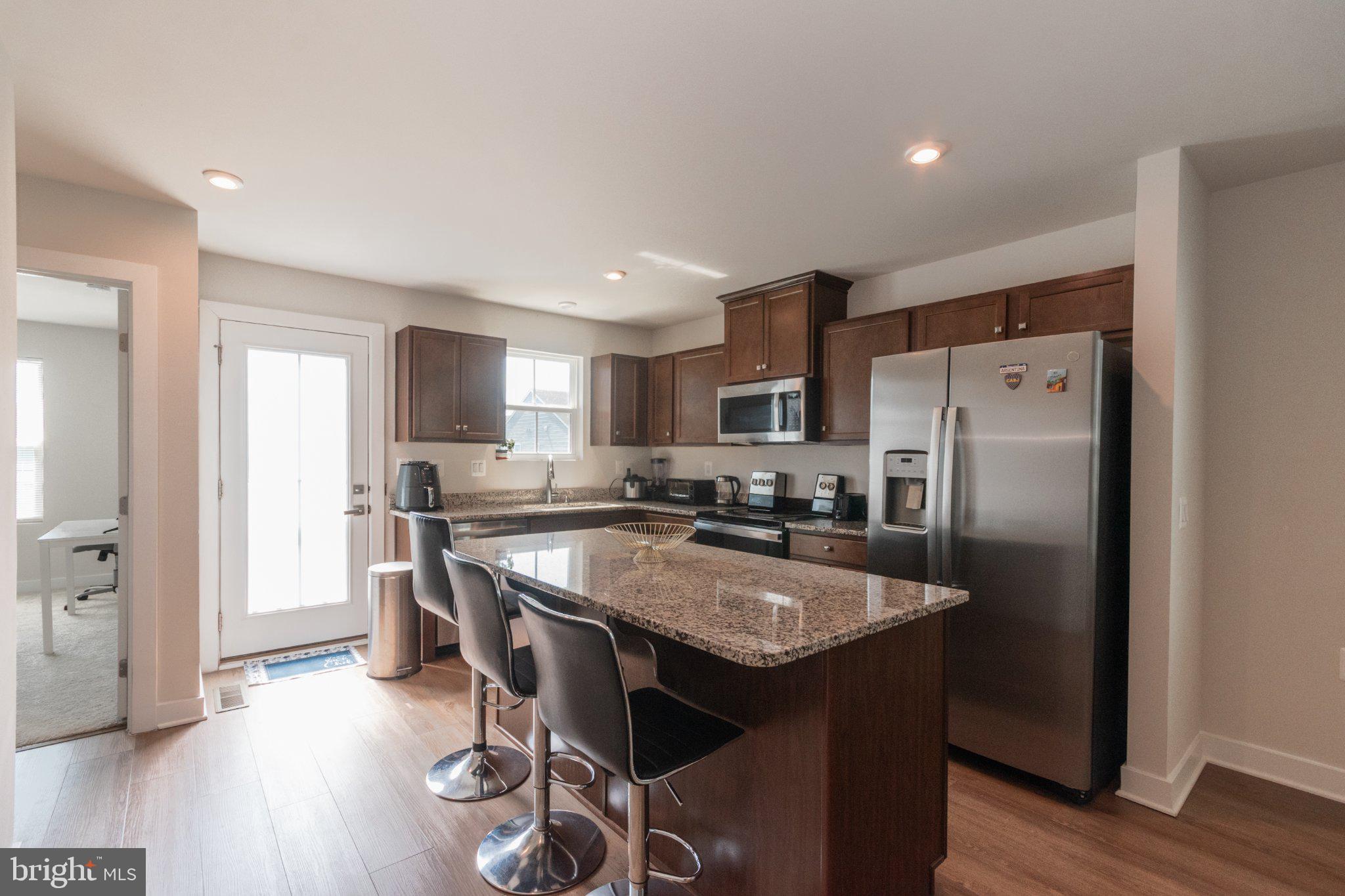 109 Blantons Road Martinsburg, WV 25405 - Photo 20 of 55 a kitchen with stainless steel appliances granite countertop a table chairs refrigerator and sink