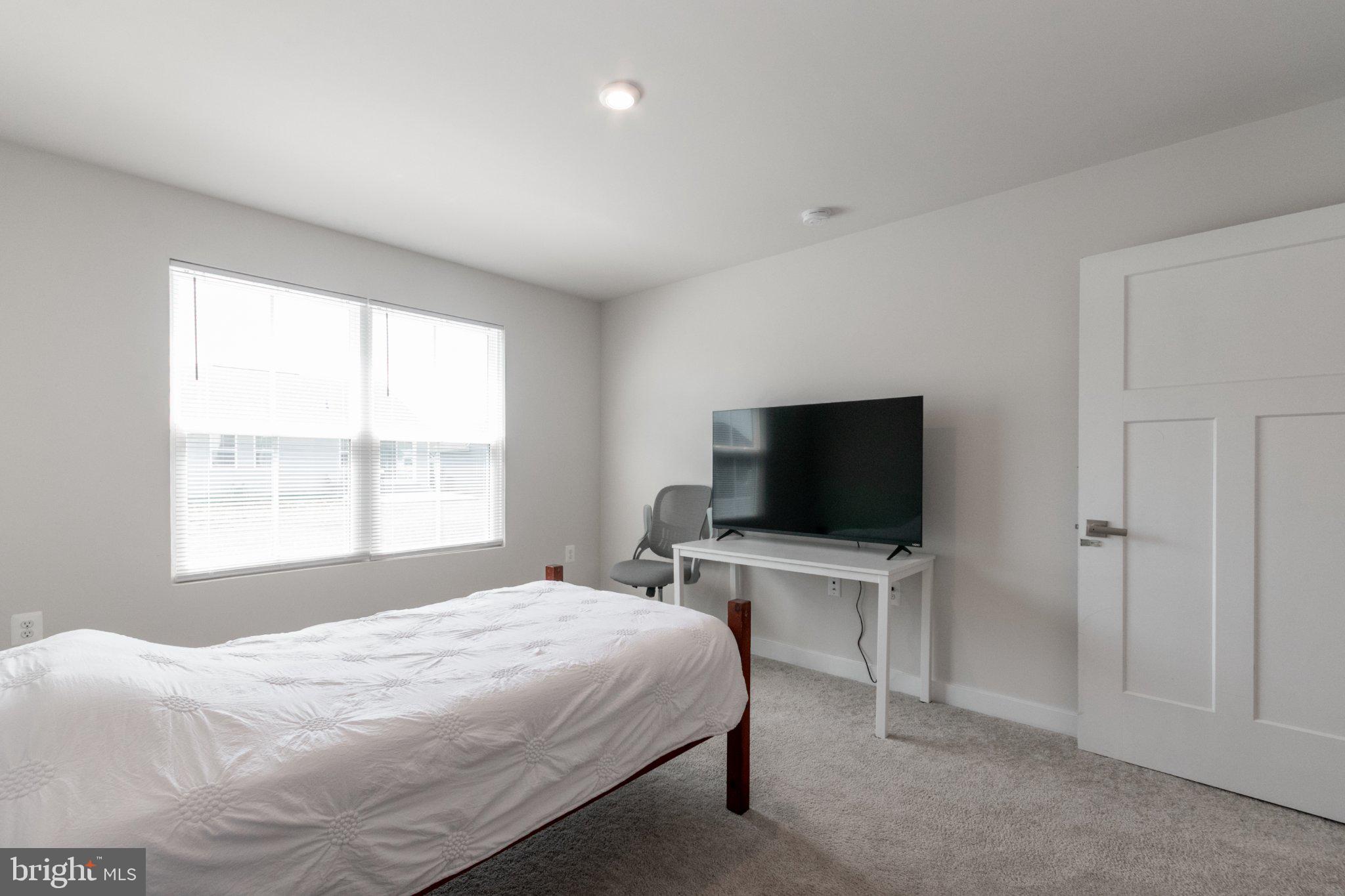 109 Blantons Road Martinsburg, WV 25405 - Photo 33 of 55 a bedroom with a bed and a flat screen tv