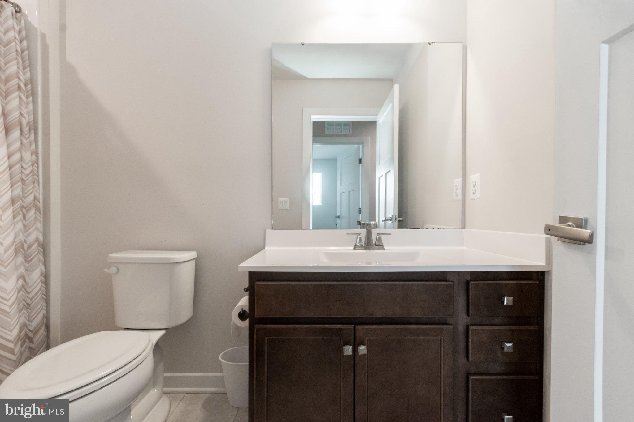 109 Blantons Road Martinsburg, WV 25405 - Photo 42 of 55 a bathroom with a toilet a sink and mirror