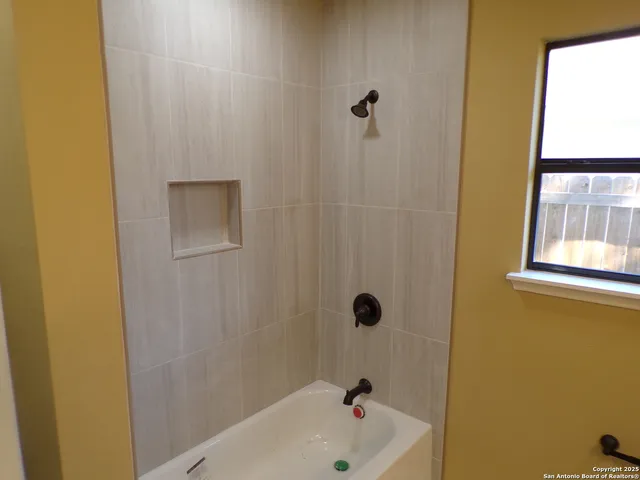 a bathroom with a tub and a shower