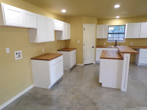 a kitchen with a sink stove and cabinets