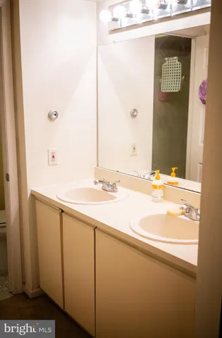 a white toilet sitting next to a white sink