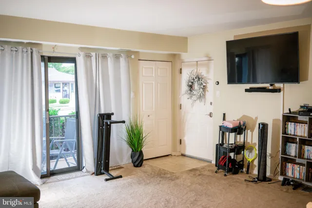 a view of a livingroom with furniture and a flat screen tv